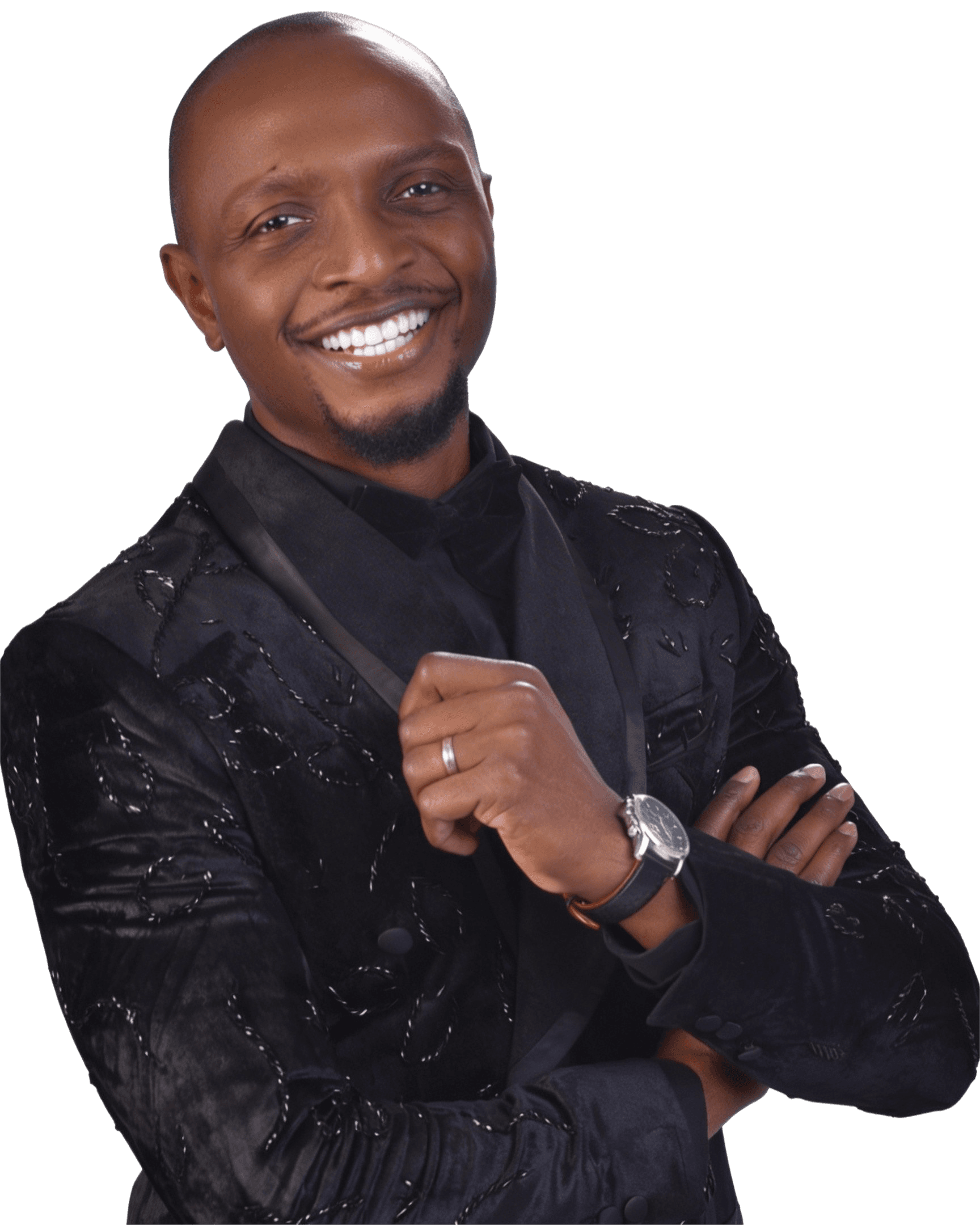 AK smiling in a black formal suit